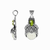 Balinese bone face pendant with peridot quartz in sterling silver, handcrafted jewelry.
